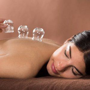 Woman Lying On Front Receiving Cupping Treatment On Back